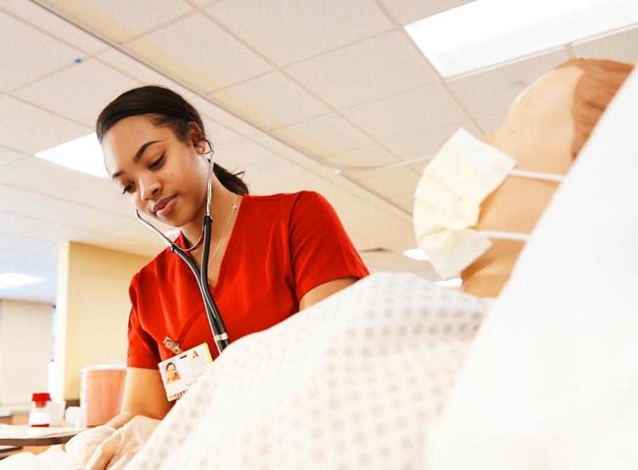 Nursing student works in a sim lab